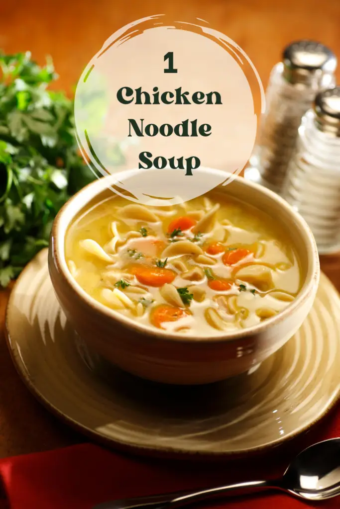 A bowl of golden chicken noodle soup with fresh parsley on a wooden table.