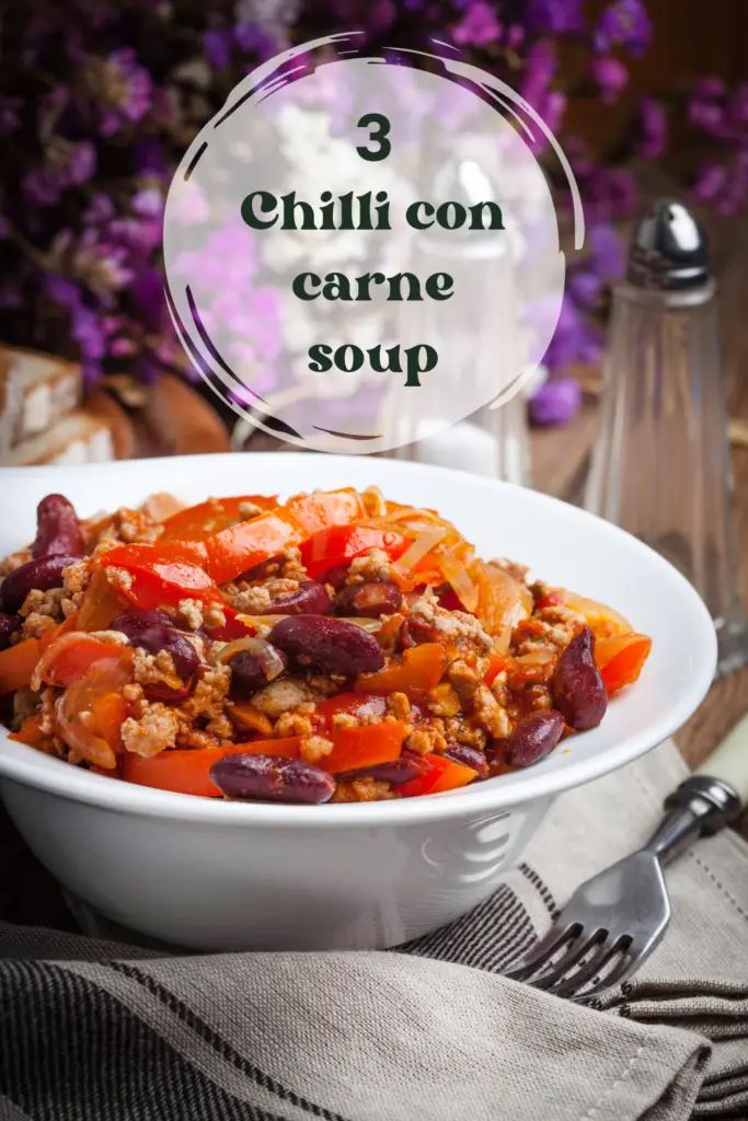 A close-up of a hearty bowl of Chilli Con Carne soup featuring kidney beans, ground beef, and bell peppers.