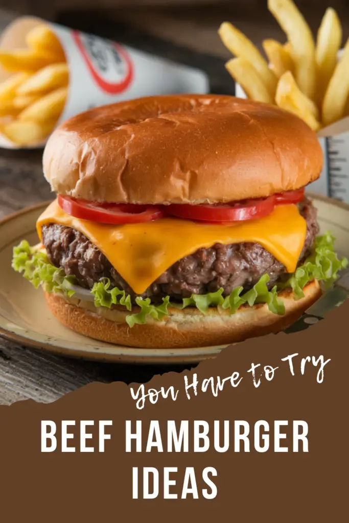 A juicy beef hamburger with melted cheddar cheese, fresh tomato slices, and lettuce, served alongside a portion of golden French fries.