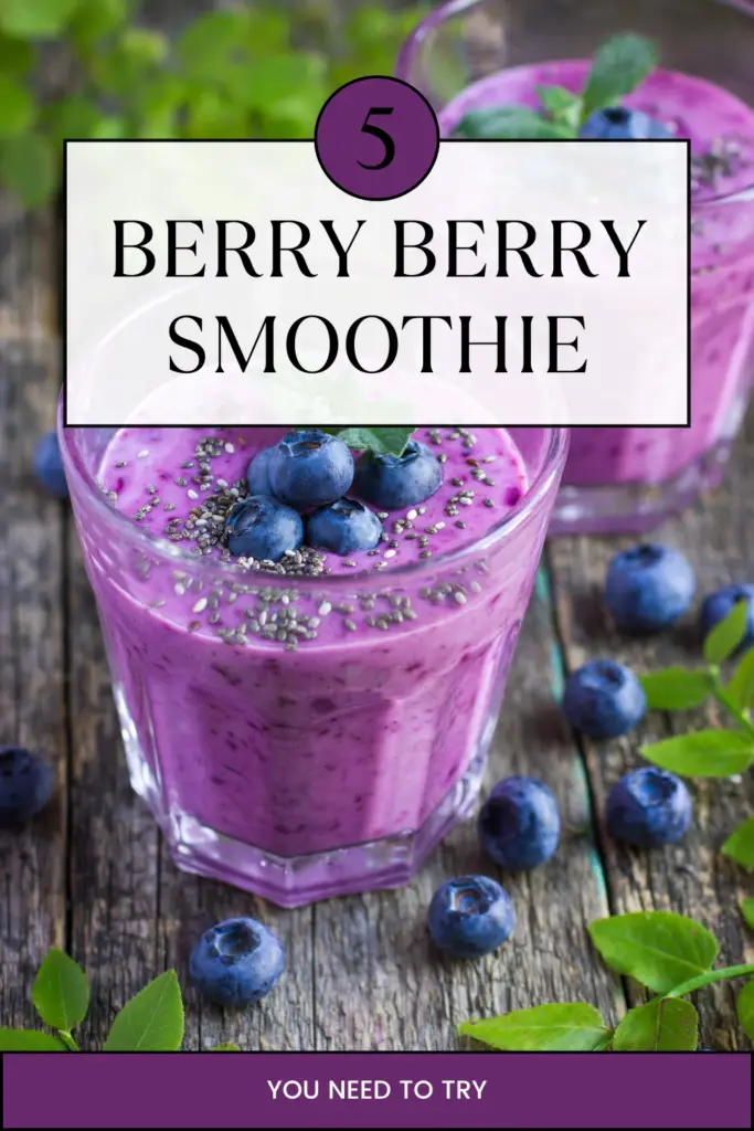 A vibrant blueberry smoothie topped with fresh blueberries and chia seeds in a glass on a rustic wooden table.