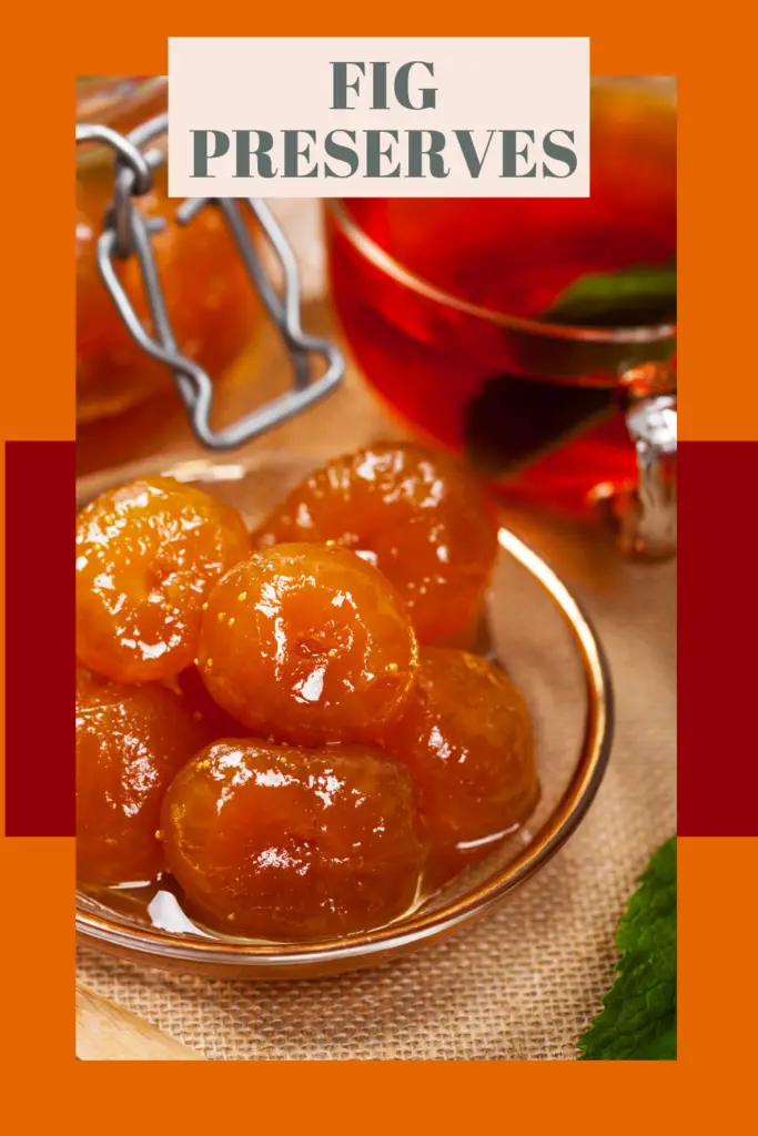 Golden whole fig preserves in a small glass bowl with a mason jar clasp visible in the background, set on a burlap cloth with an amber-colored tea or beverage in a glass cup.