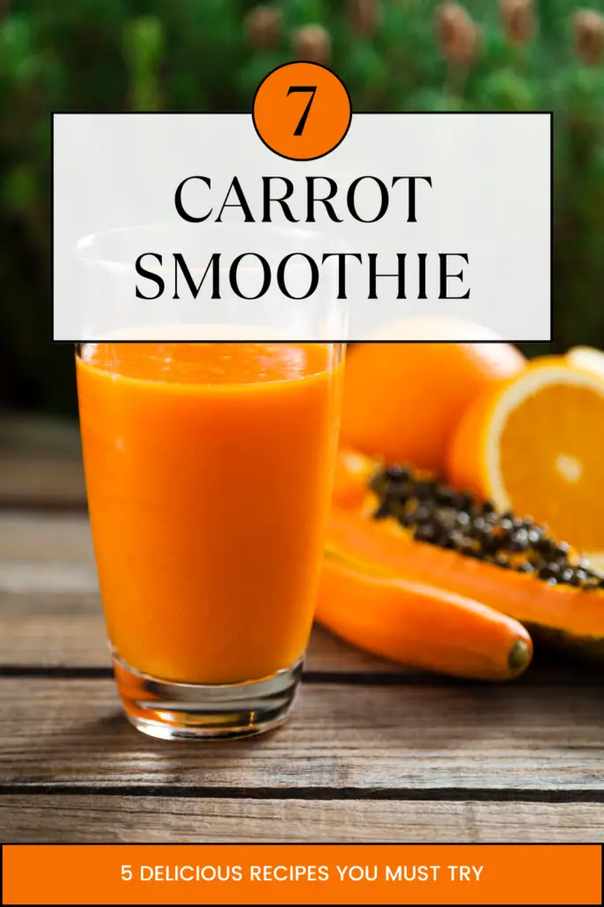 A vibrant glass of carrot smoothie placed on a rustic wooden table, surrounded by fresh oranges, papaya, and carrots.