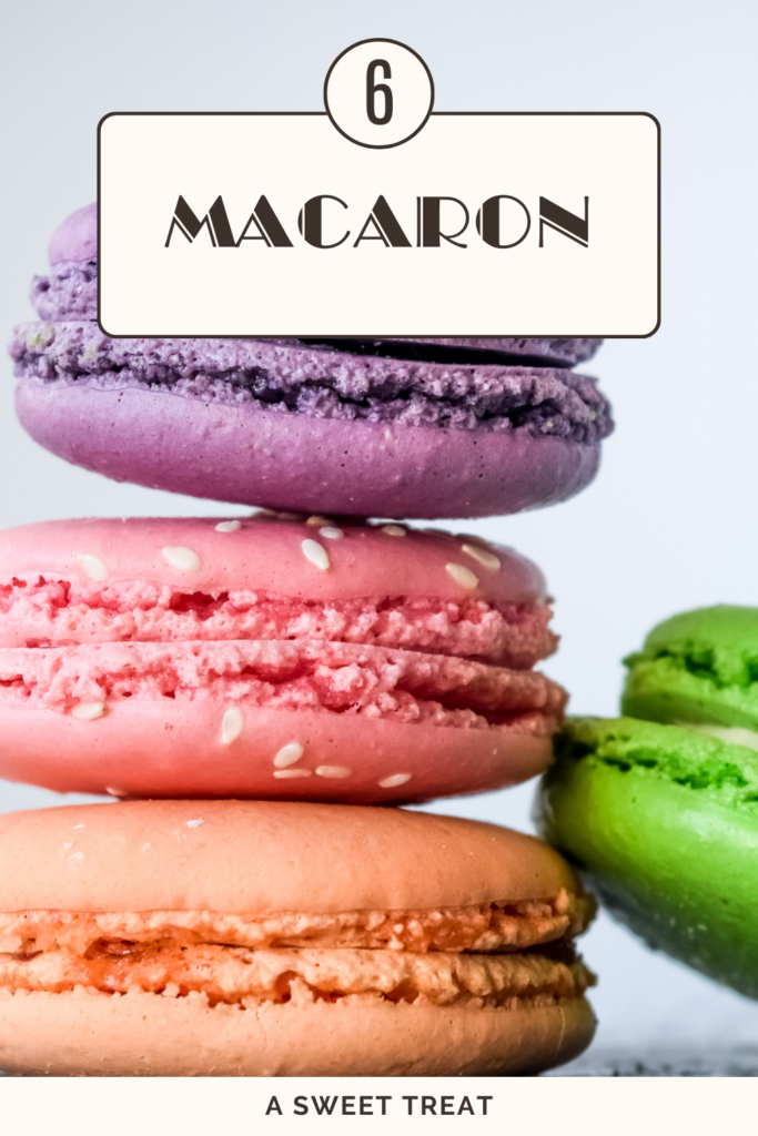 A stack of colorful macarons, including purple, pink, and green, highlighting their delicate texture.